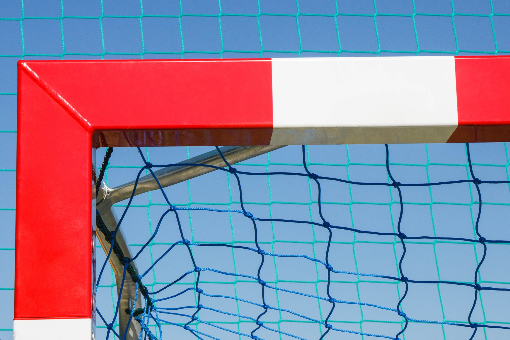 Football or handball goal with red and white goalpost