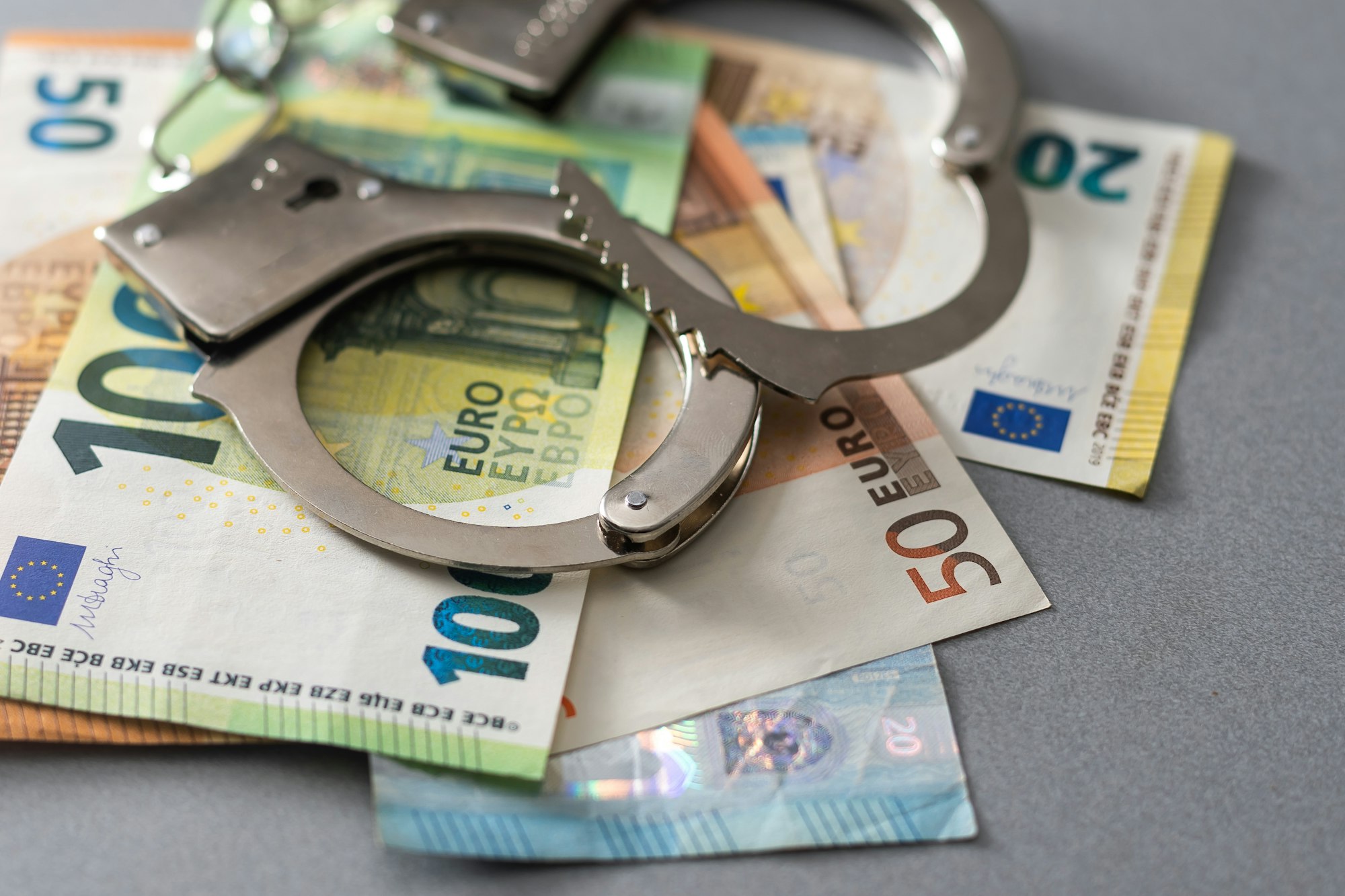 Euro banknotes and metal handcuffs. Concept For Corruption or Fraud